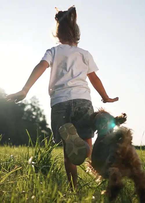 Child running with a dog